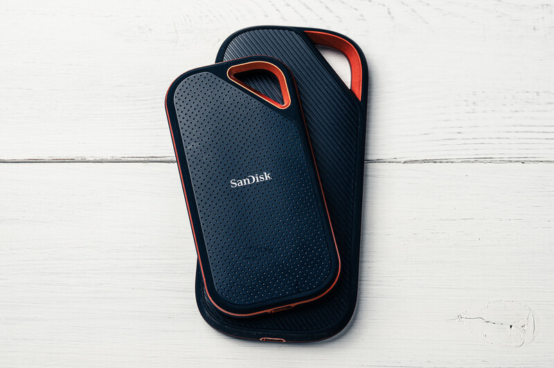 SanDisk Extreme portable solid-state drive with dark blue rubberized casing and orange accent handles.