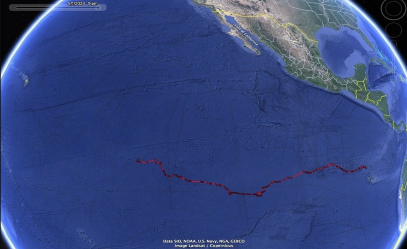 Satellite map showing Earth with a red line tracing an oceanic path in the Pacific.