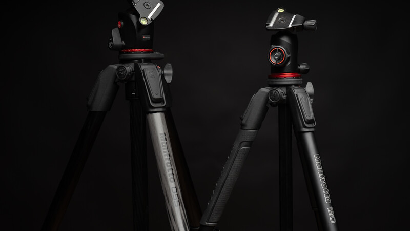 Two professional tripods with fluid heads against a black background, showing different pan-tilt mechanisms and leg designs.
