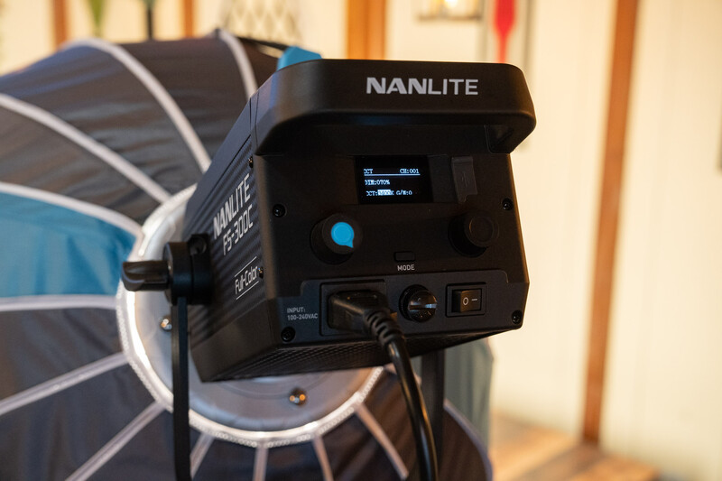 Nanlite LED light fixture mounted on stand with reflector and control panel visible.