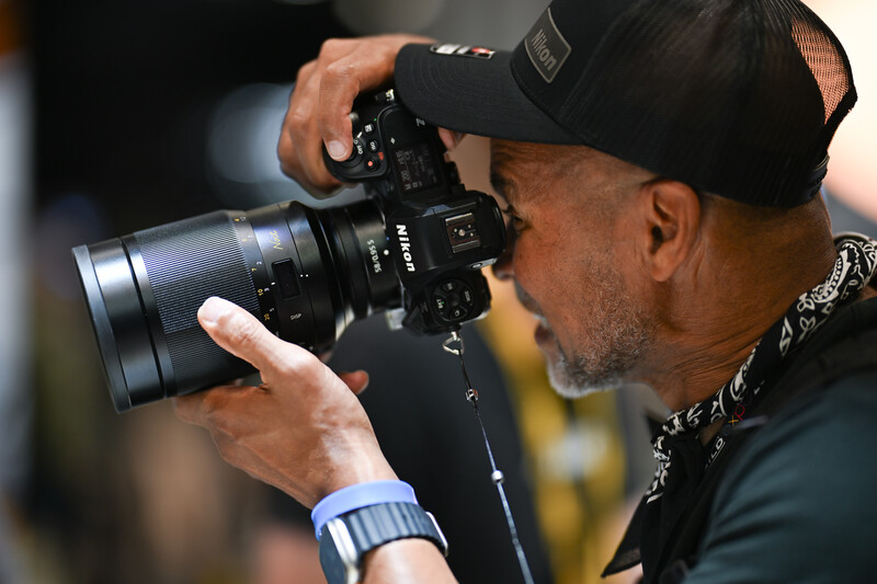 Man looking through camera viewfinder