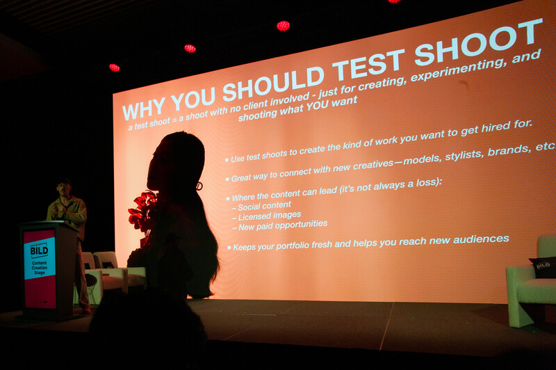 Speaker presenting slide titled 'Why You Should Test Shoot' at photography conference.