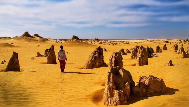 A girl walking through the Pinnacles on the West of Australia 
