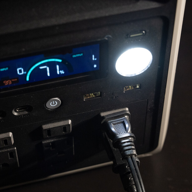 Close-up of a car dashboard with illuminated gauge cluster and bright overhead dome light activated.