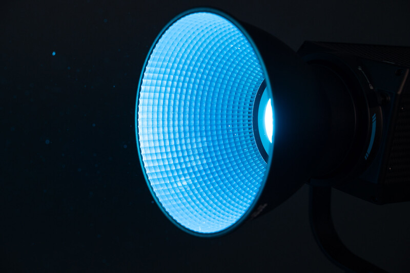 Large-format LED panel with bright blue pixelated grid pattern glowing against dark background.