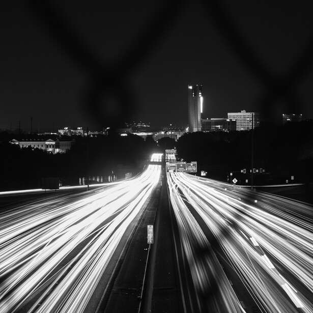 Black and white photo of freeway car light trails in Atlanta