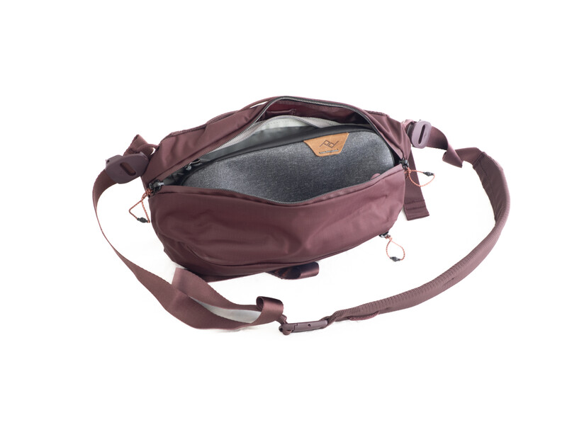 Burgundy shoulder bag with gray interior compartment open to show storage space.