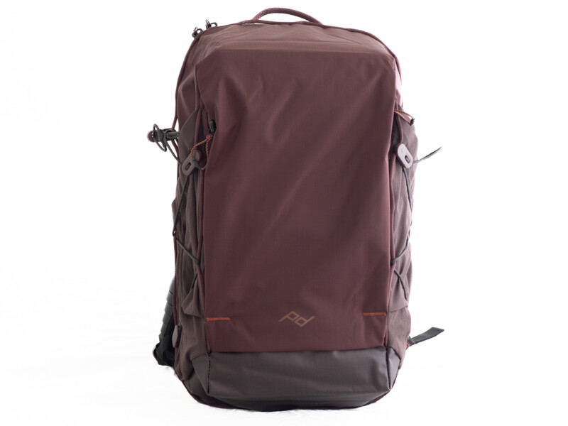 Burgundy and charcoal travel backpack with padded shoulder straps and side compression straps.
