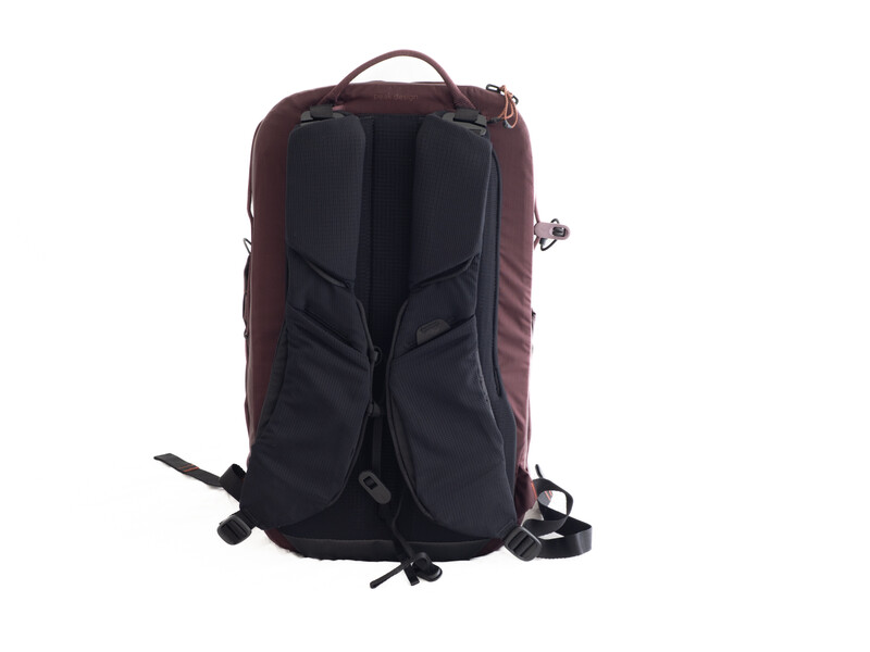Burgundy and black backpack photographed against a white background, showing rear panel and straps.