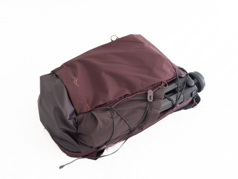 Burgundy and charcoal hiking backpack with compression straps and attached gear loops, photographed against white background.