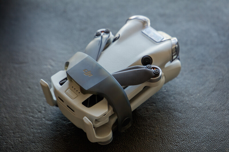 DJI Mavic Air 2 compact drone displayed from above on dark textured surface.
