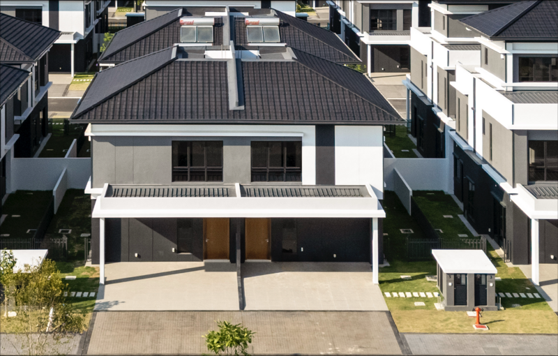 Modern two-story residential home with dark roof and white facade photographed from above at daytime.