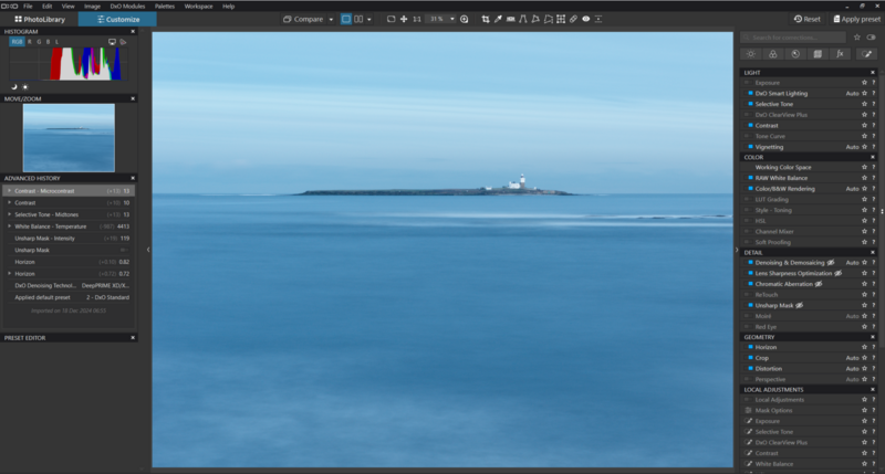 Screenshot of photo editing software showing a serene seascape with calm blue water and a distant island or landmass.