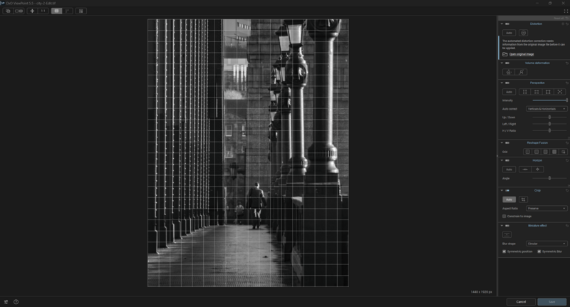 Black and white photograph of a narrow urban alley between tall buildings with geometric grid overlay.
