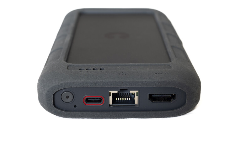 Rear view of a portable storage device with USB, Ethernet, and HDMI ports visible.