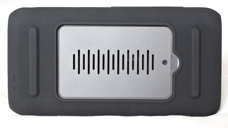 Portable audio device with dark gray exterior and silver speaker grille panel.
