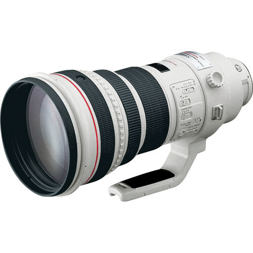 White telephoto zoom lens with multiple barrel sections and focus ring.