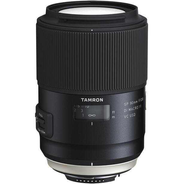 Tamron SP 90mm f/2.8 macro lens with vertically ribbed black barrel and focus ring against white background.