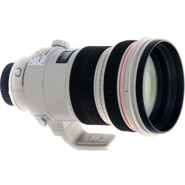 White telephoto lens with black focus ring and red accents, shown against white background.