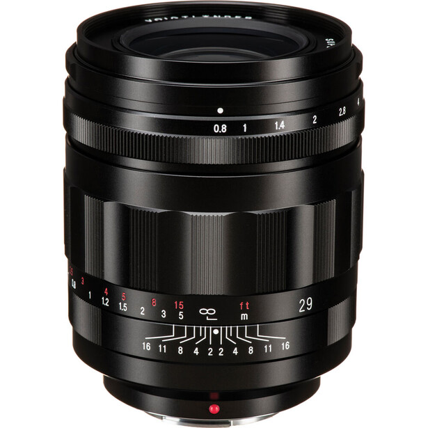 Vintage camera lens with manual focus ring and aperture scale markings displayed against white background.