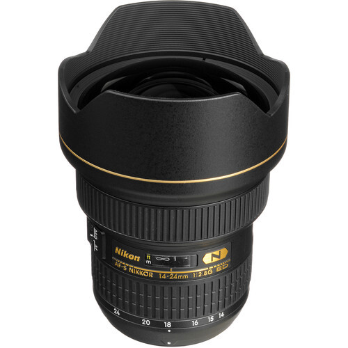 Nikon 14-24mm f/2.8G wide-angle lens with hood attached, displayed against white background.