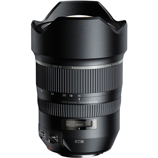 Black telephoto lens with dual zoom rings and lens hood against white background.