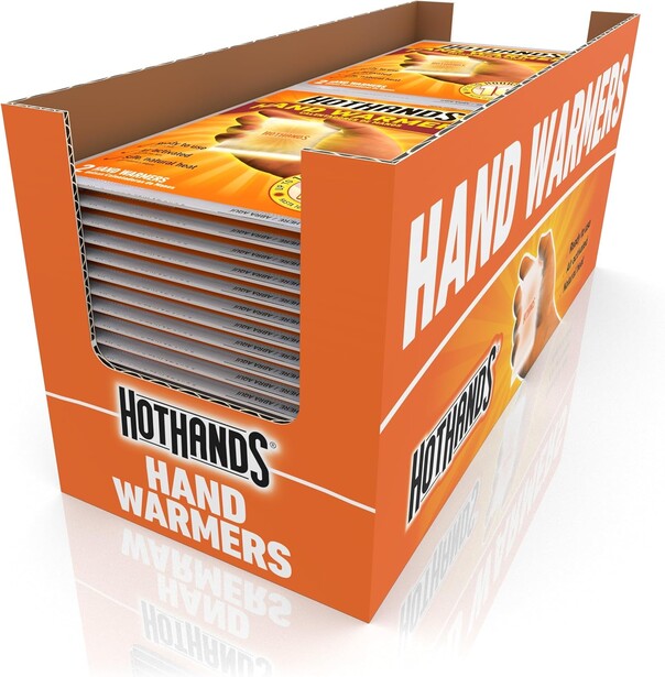 Product display box for hand warmers showing stacked individual packages with orange and white branding.