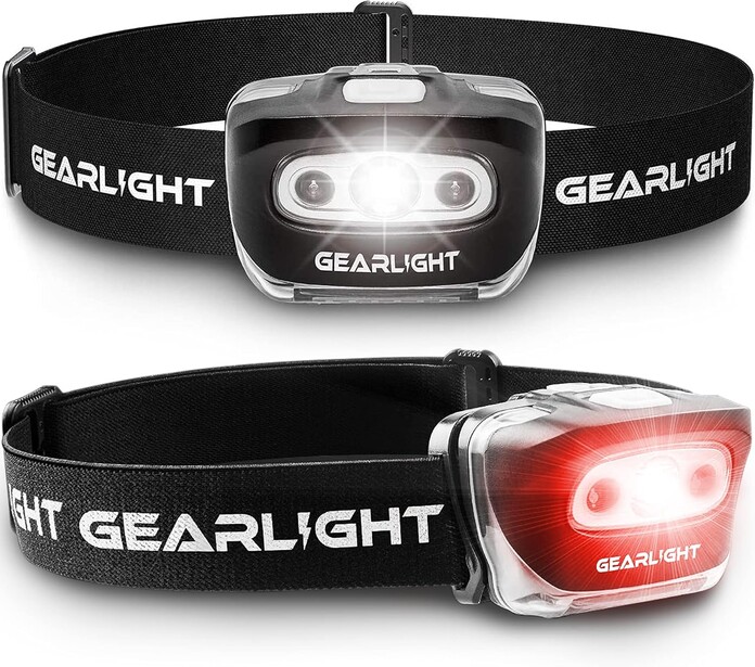 Two black headlamp designs showing white LED front lights and red rear lights with adjustable fabric straps.