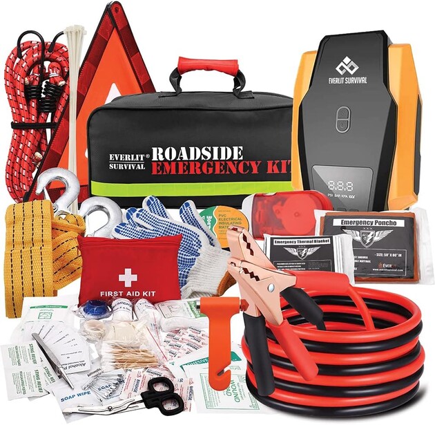 Roadside emergency kit with jumper cables, first aid supplies, and safety equipment organized and displayed.