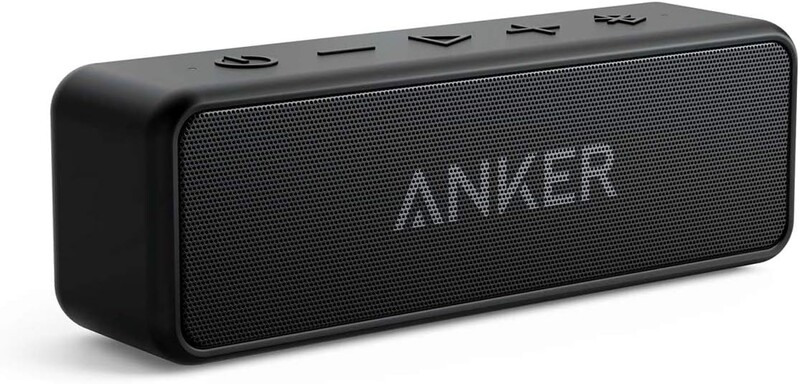 Black portable Bluetooth speaker with textured mesh grille and control buttons on top.