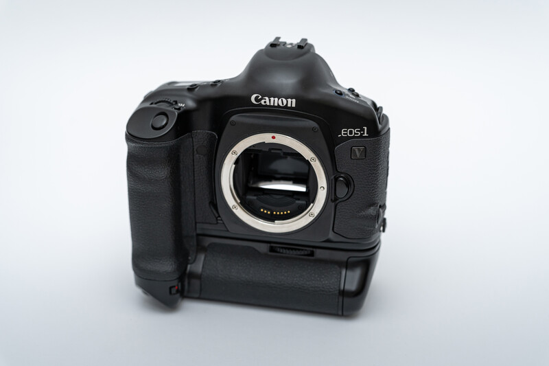Canon EOS-1 DSLR camera body with battery grip attached, showing open mirror box and sensor.