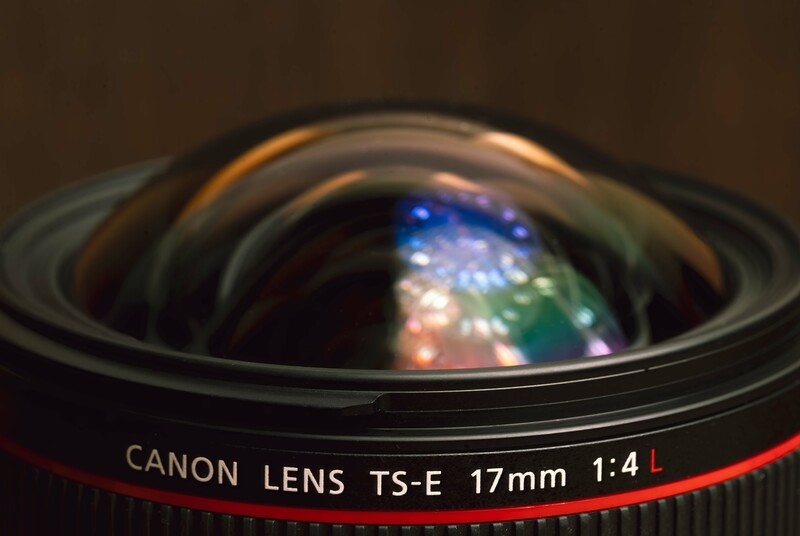 Canon TS-E 17mm f/4L tilt-shift lens with front element visible against dark background.