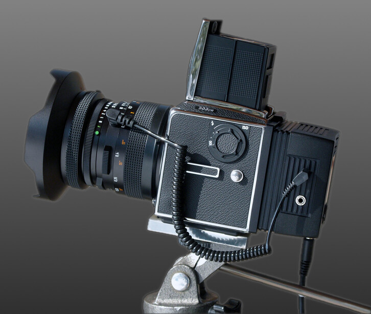 Hasselblad 500C/M medium format camera mounted on tripod with lens, viewfinder, and accessory equipment.