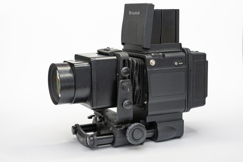 Hasselblad 500-series medium format camera with lens, prism viewfinder, and motorized film back on white background.