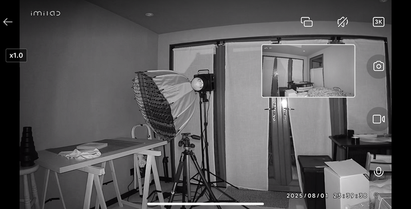 Studio setup with softbox lighting, reflector, and backdrop frame in monochrome.