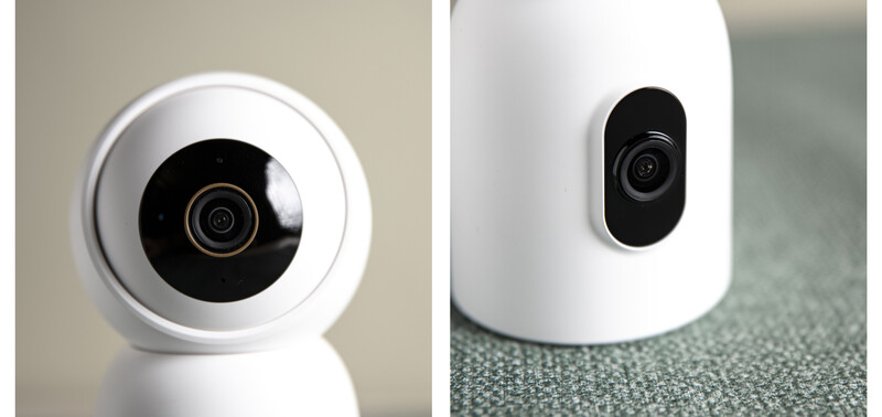 Two white compact security cameras shown from front and side angles, displaying black lens housings with concentric ring details.
