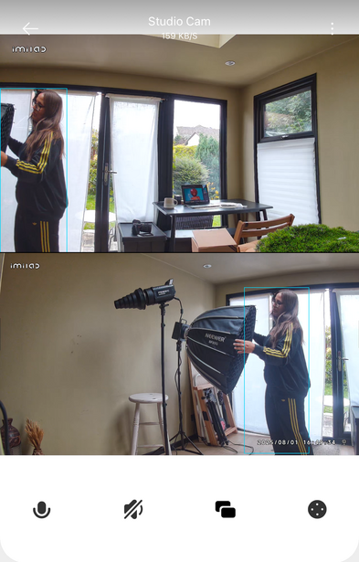 Screenshot of a video interface showing two stacked frames of a person adjusting studio lighting equipment near large windows.
