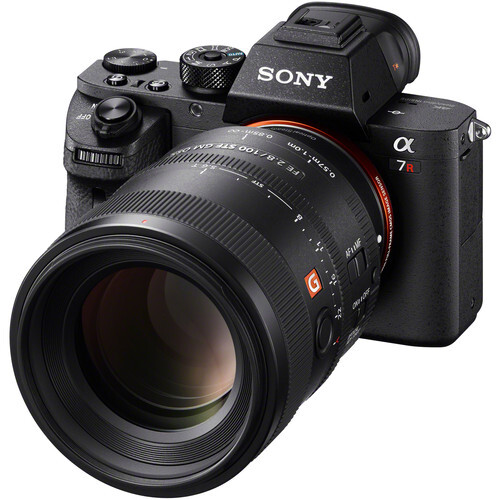 Sony α7r mirrorless camera with telephoto lens attached, shown at three-quarter angle against white background.