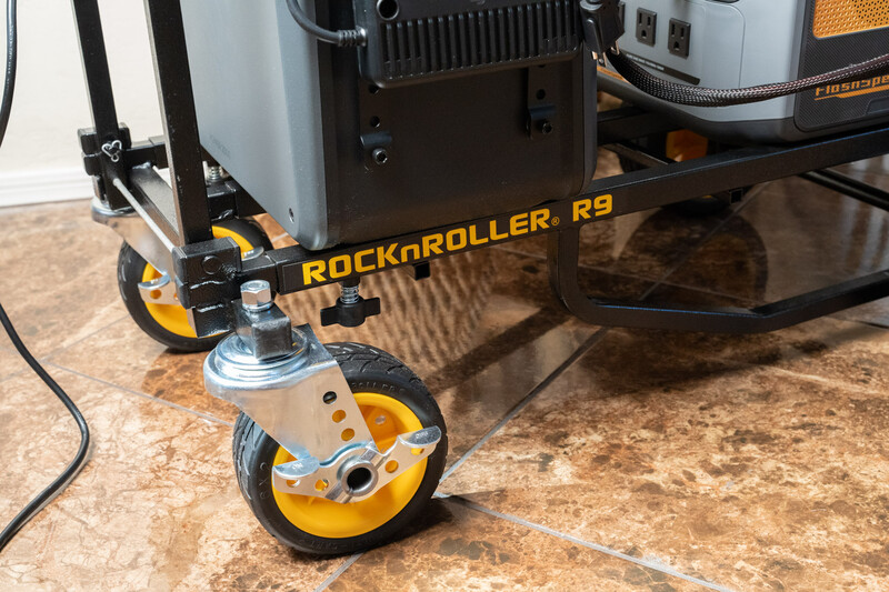 RockRoller R9 equipment cart with yellow and black frame and wheels on a concrete floor.