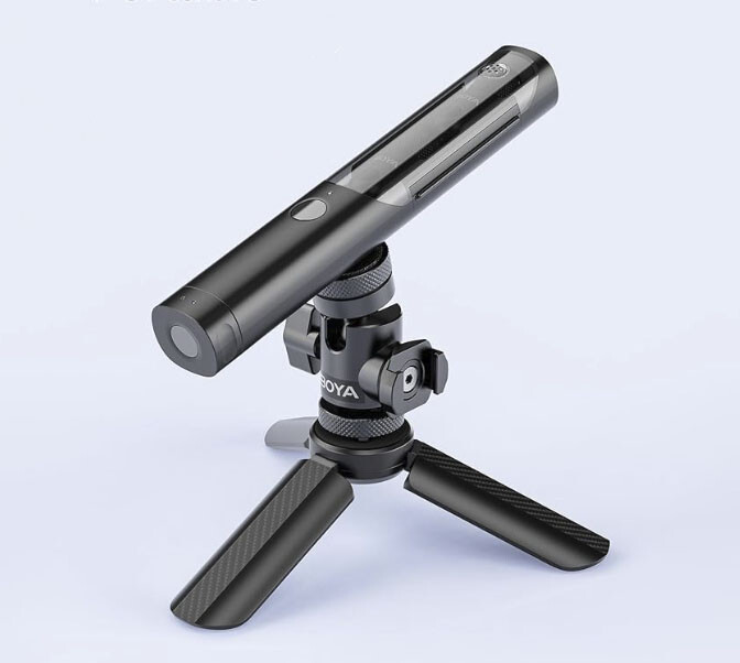 Shotgun microphone mounted on a tripod with ball head and compact legs.