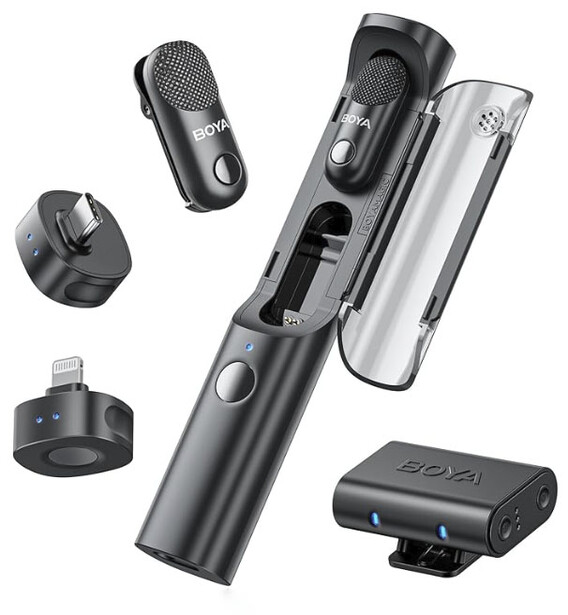Product display showing a wireless microphone system with handheld transmitter, receiver, windscreen, and mounting accessories arranged on white background.