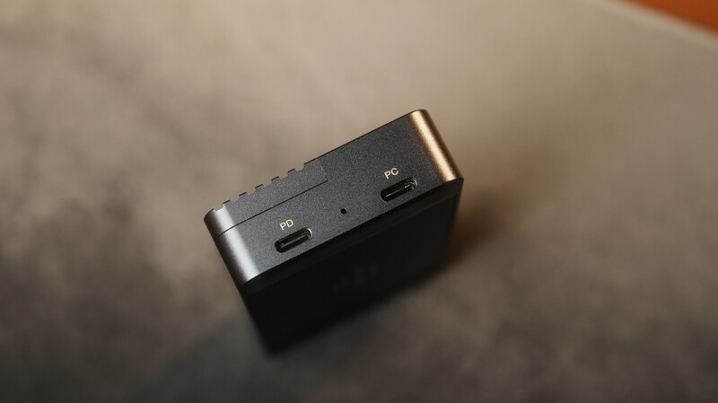 Compact audio interface or portable recorder with metal housing and USB connectivity ports visible on top.