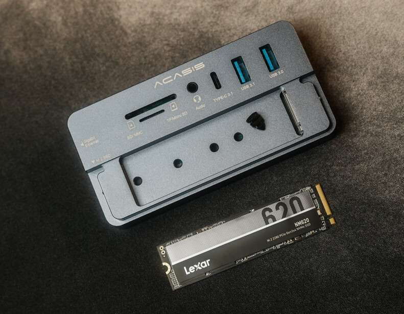 ASUS card reader and Lexor NM SSD displayed on neutral fabric surface.