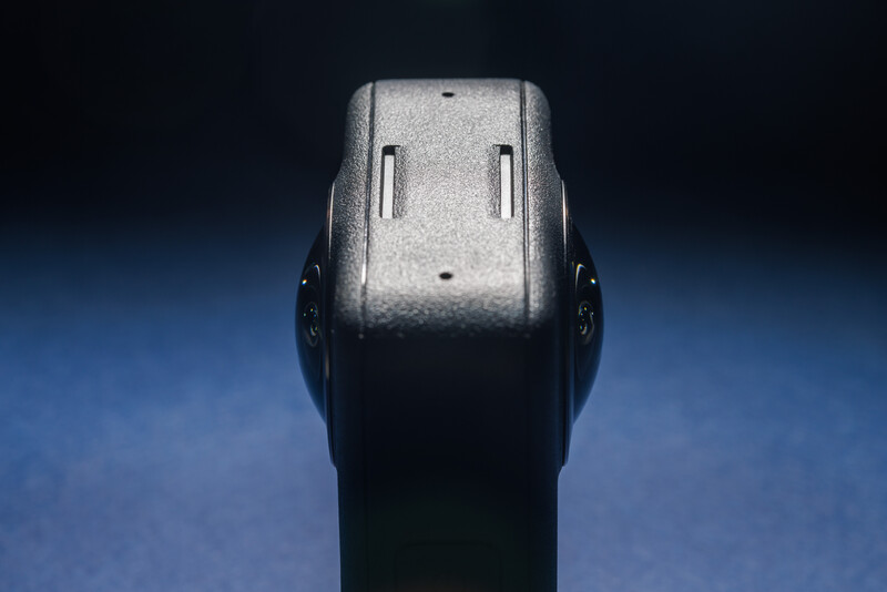 Close-up of a gun's rear sight assembly against a blue and black gradient background.