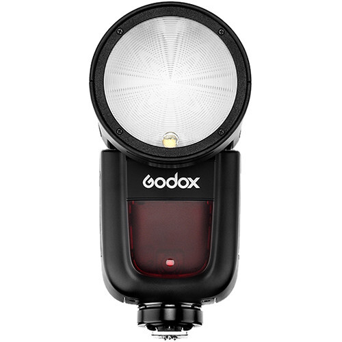 Godox speedlight flash with dome diffuser attachment and dark red battery compartment.