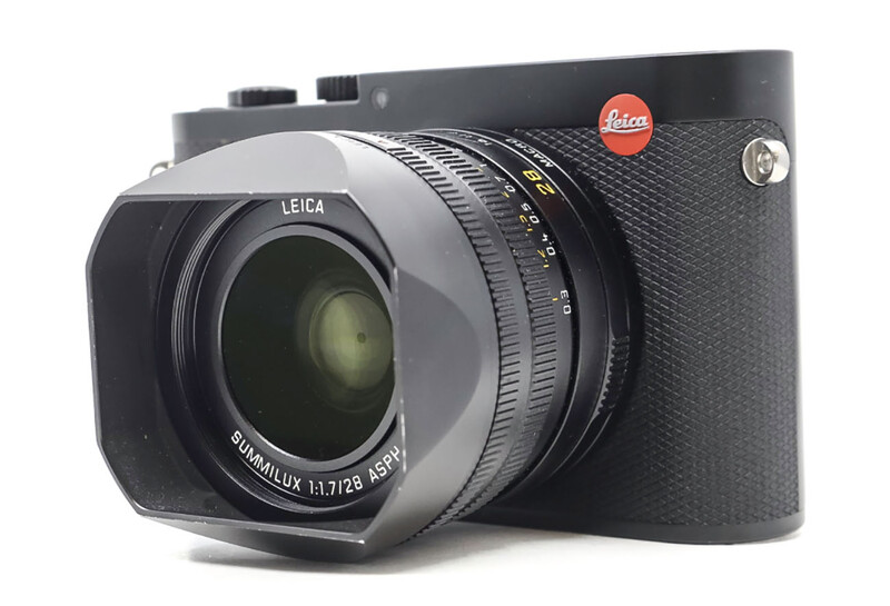 Leica Q2 rangefinder camera with attached lens hood, shown from three-quarter view against white background.
