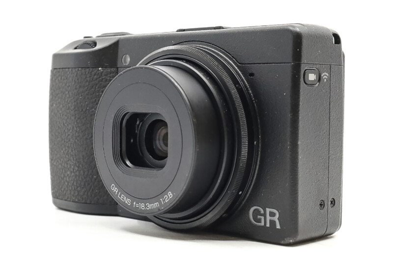 Ricoh GR compact digital camera with fixed lens against white background.