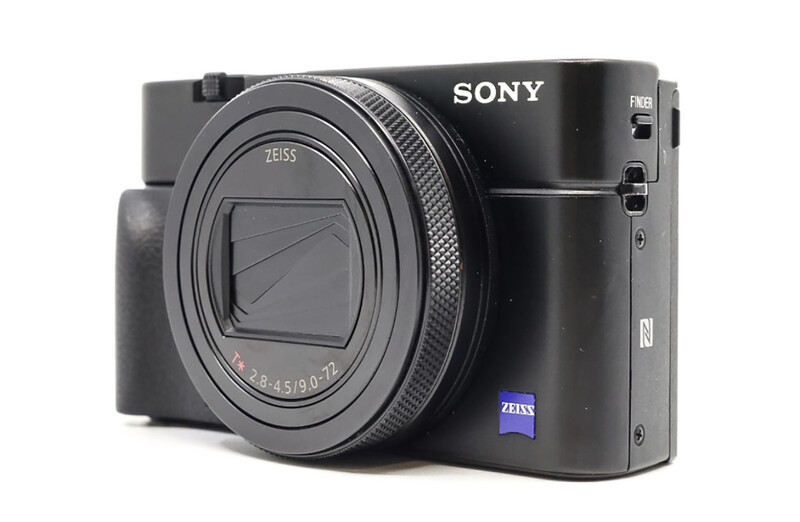 Sony RX100 compact camera with Zeiss lens, shown from the right side against a white background.