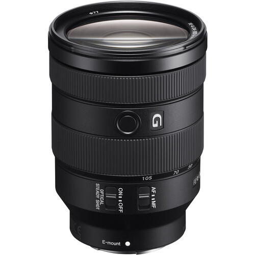 Black telephoto lens with focus ring and distance scale markings against white background.