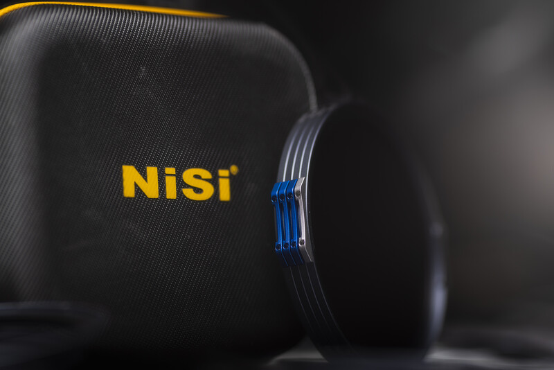 NiSi filter case with yellow branding and blue filter wraps on dark textured background.